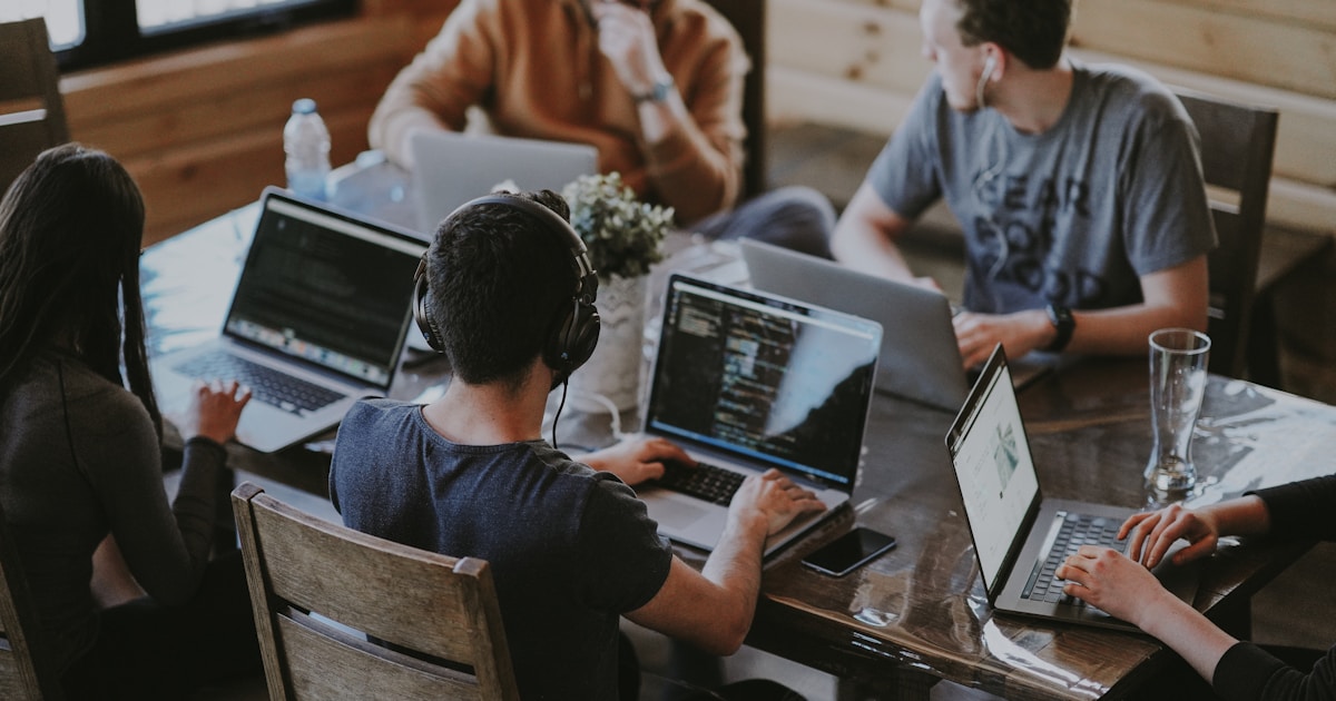 Team collaborating asynchronously with digital tools and communication platforms